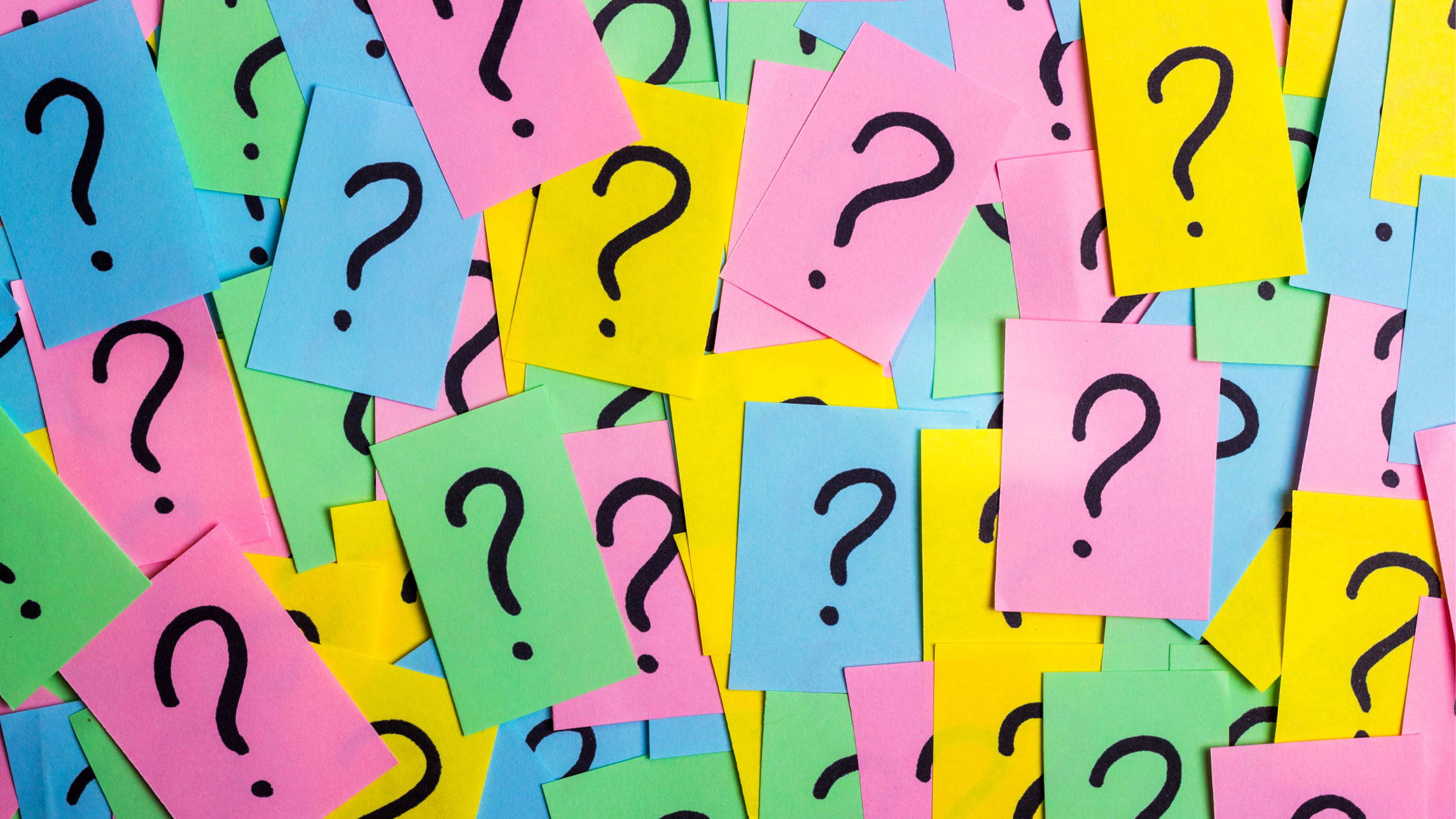 Colourful sticky notes with question marks written on them.